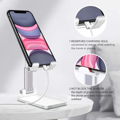 A white adjustable phone stand holding a smartphone with a charging cable plugged in.