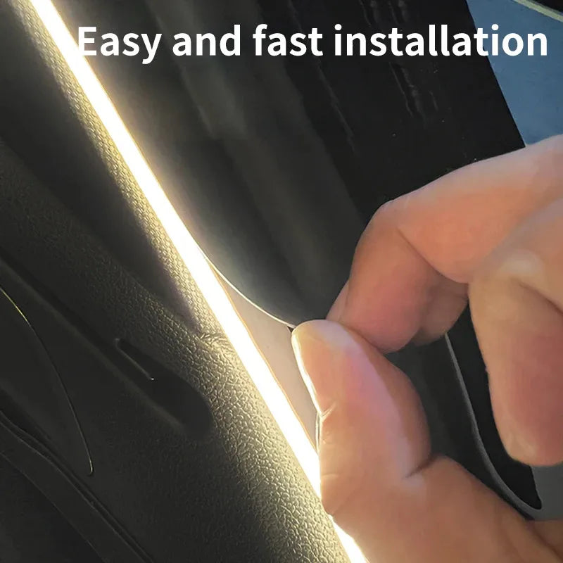 A hand installs a flexible, bright white LED light strip into a car's interior trim.