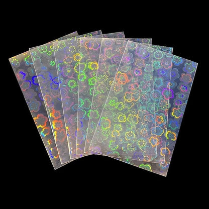 Seven holographic card sleeves fan out, covered in a shimmering pattern of multicolored, rainbow flower shapes.