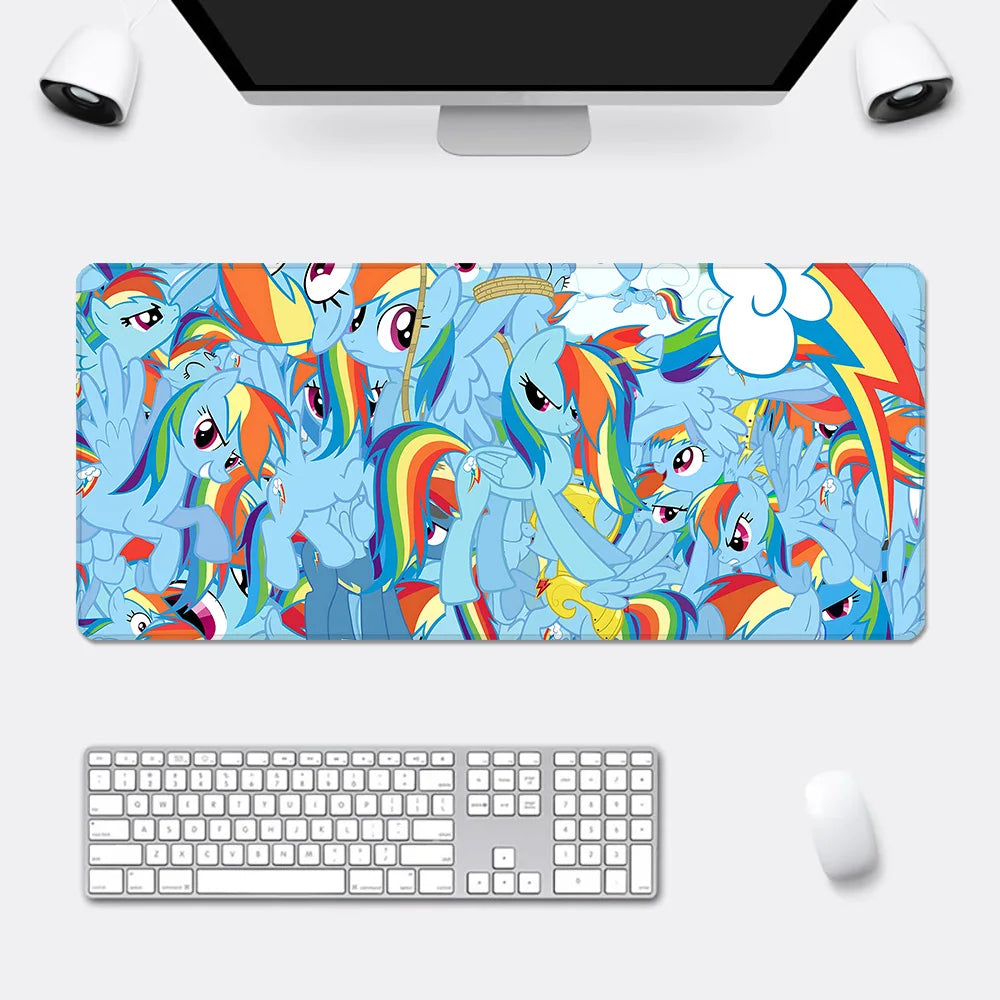 A large mousepad features a vibrant blue collage of Rainbow Dash characters with rainbow manes.