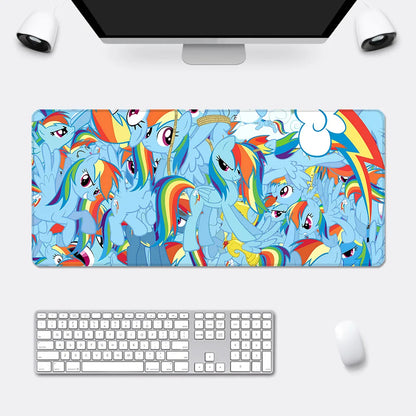 A large mousepad features a vibrant blue collage of Rainbow Dash characters with rainbow manes.