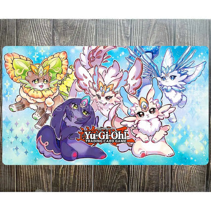 Yu-Gi-Oh playmat with five stylized fantasy creatures in yellow, purple, white, and blue against a light blue, sparkly background.