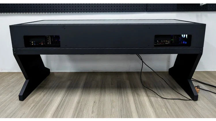 Black computer chassis integrated table with dual host compartments and Z-shaped legs on a wood floor.