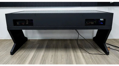 Black computer chassis integrated table with dual host compartments and Z-shaped legs on a wood floor.