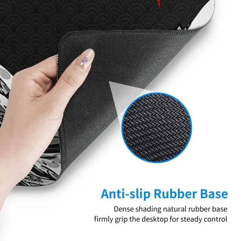 A hand lifts the corner of a black desk mat, revealing a textured, anti-slip rubber base, with a close-up circle.
