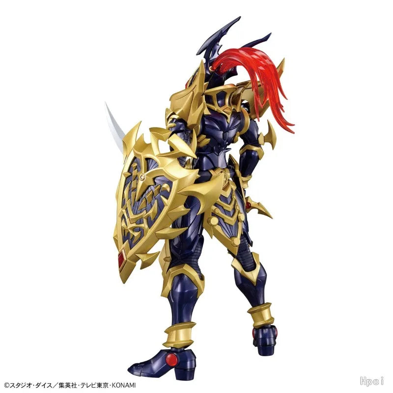 Rear view of a dark blue and gold armored action figure with a flowing red crest, holding a shield.