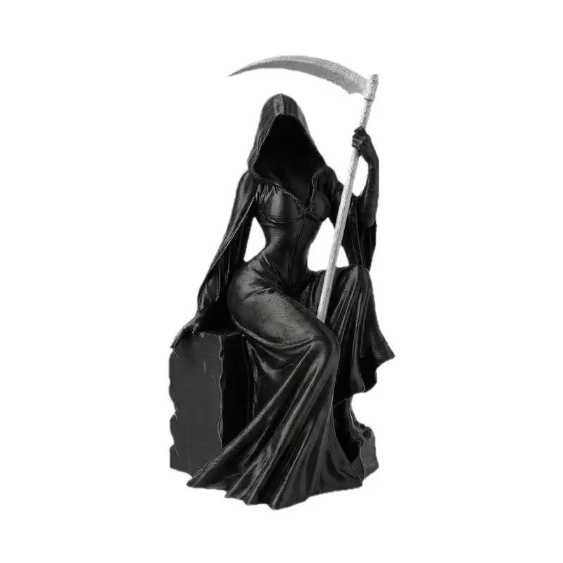A black statue of a hooded female Grim Reaper sitting on a block and holding a scythe with a silver blade.