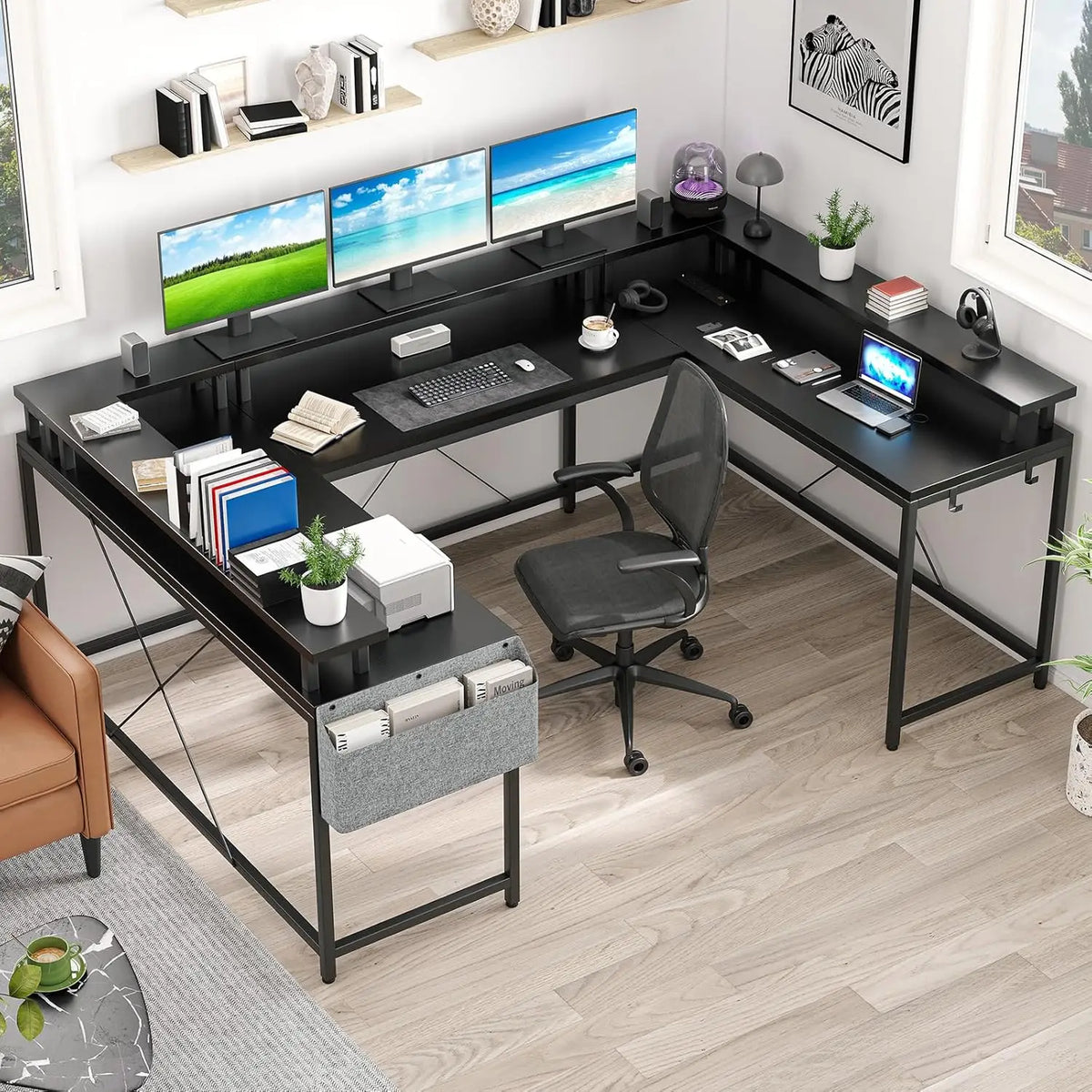 Large black U-shaped gaming desk with a raised monitor shelf, three computer monitors, and an office chair.