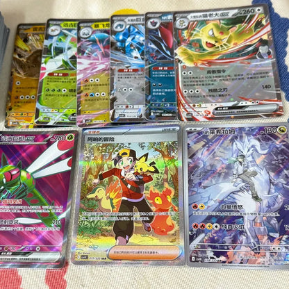 A collection of holographic Pokémon cards featuring characters like Persian, Reshiram, and trainer cards in Chinese.