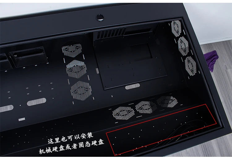 A large black computer chassis desk with multiple fan vents and internal mounting trays.