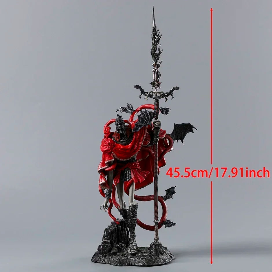 Grey horned figurine in red robes holding a tall spear, with small black wings and a height of 45.5cm/17.91inch.