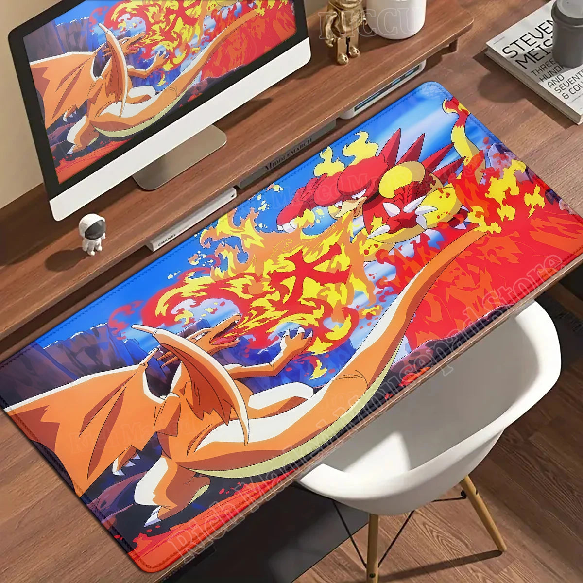 Charizard breathes fire at Magmar on a blue-and-red anime desk mat.