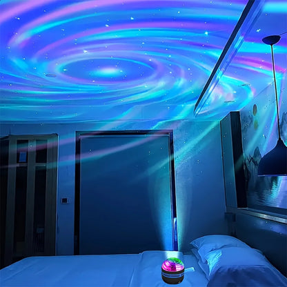 A small black projector on a bed casts blue, pink, and white swirling galaxy lights onto a bedroom ceiling.