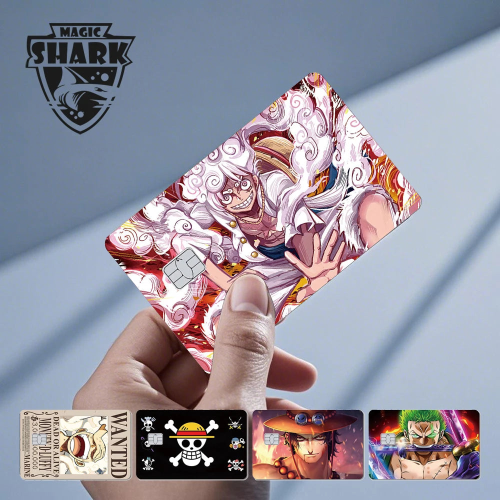 A hand holds a credit card skin sticker featuring an anime character in white hair amidst red swirls.