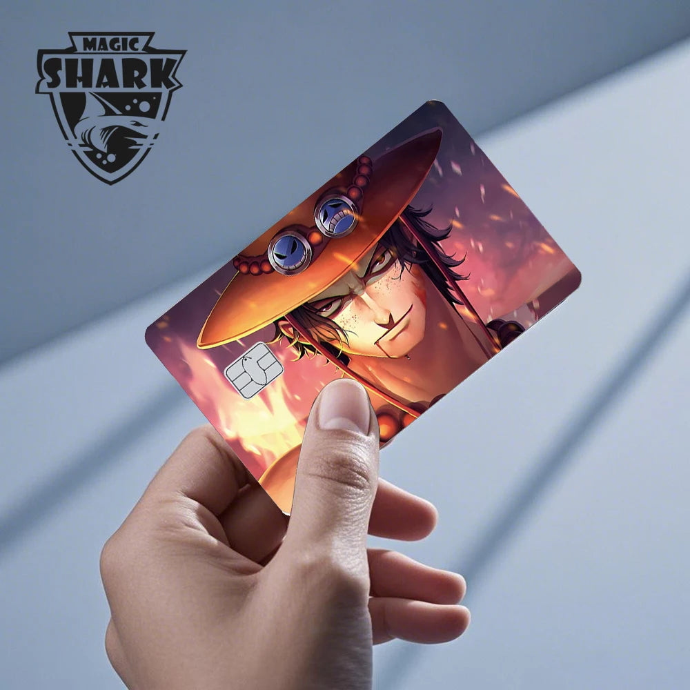 A hand holds a credit card featuring an anime character in an orange hat with goggles against a fiery background.
