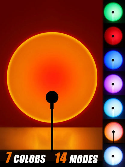 Sunset lamp on a stand casting a large orange light circle on a wall, with stacked panels showing green, red, blue, purple, and cyan lights.