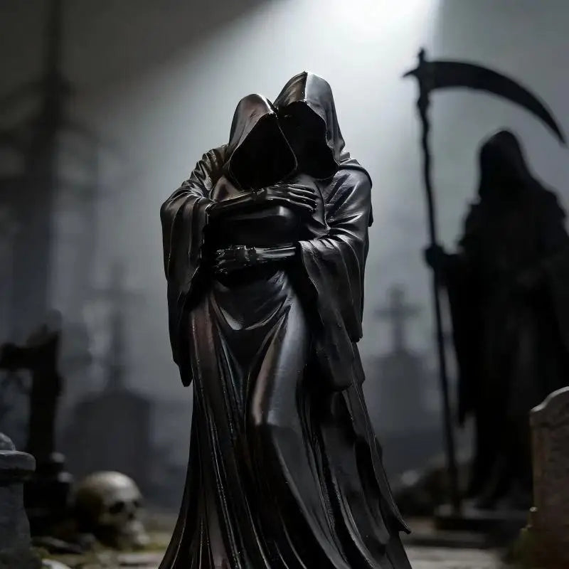 A black resin statue of two hooded figures embracing, with a shadowy scythe bearer behind.