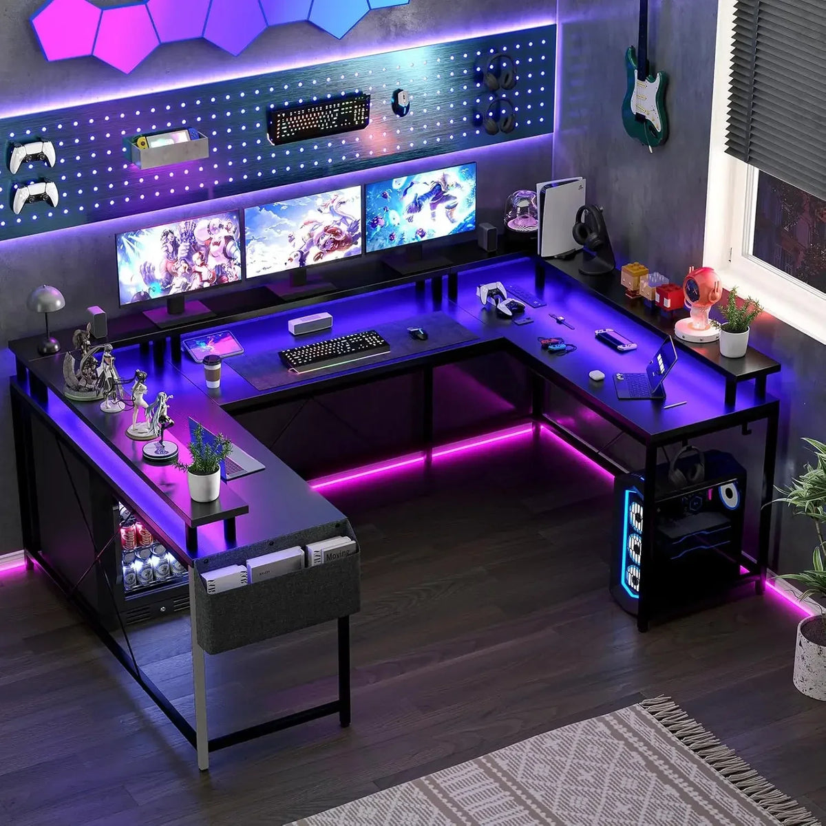 Black U-shaped gaming desk with purple LED strip, monitor stand, and computer setup.