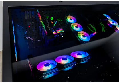 A black computer desk with a glass top reveals internal components and multiple glowing RGB fans.