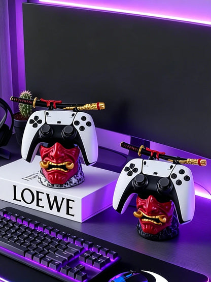 Red and gold oni mask resin game controller holders with samurai sword stands, holding game controllers.