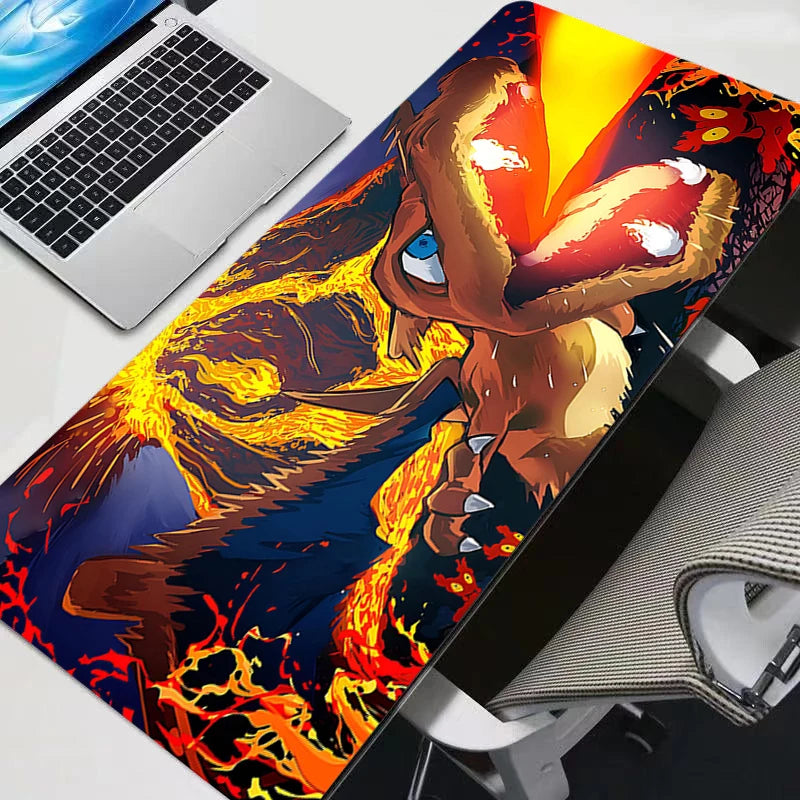 Charizard large desk mat in red, orange, and blue with volcano artwork next to a laptop.