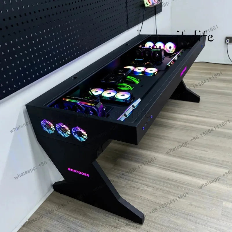 Black gaming desk with a glass top showing internal PC components and RGB cooling fans.
