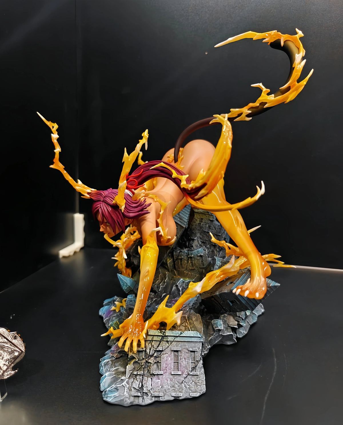 Yoruichi Shihouin anime figure crouched on a rubble base, surrounded by yellow energy effects.