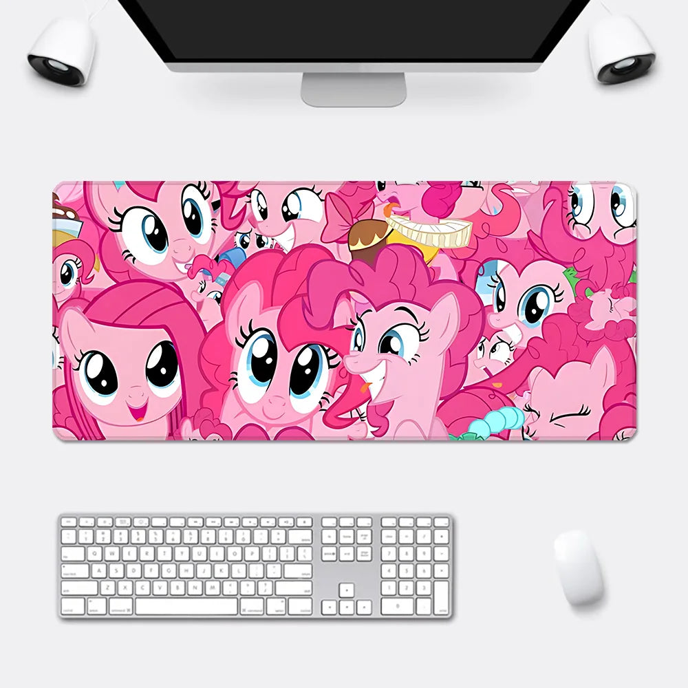 An XXL desk mousepad featuring a collage of pink My Little Pony characters with large blue eyes.