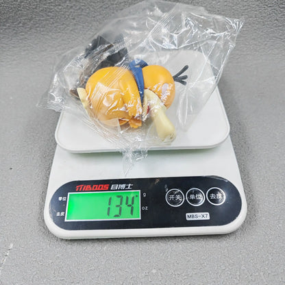 A yellow figure in a plastic bag on a digital scale reading 134g.