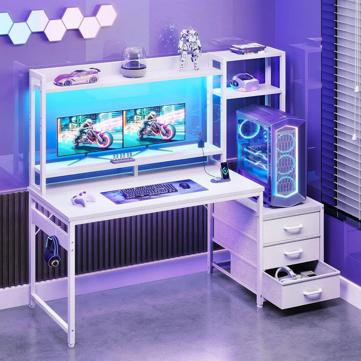 White gaming desk with hutch, monitors, keyboard, PC tower, drawers, and purple lighting.