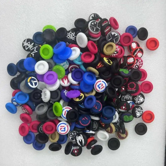 A colorful pile of various silicone thumb grip caps for gaming controllers.