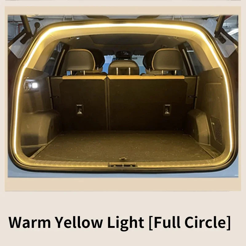 A car trunk with an arched LED light strip glowing warm yellow around the interior opening.