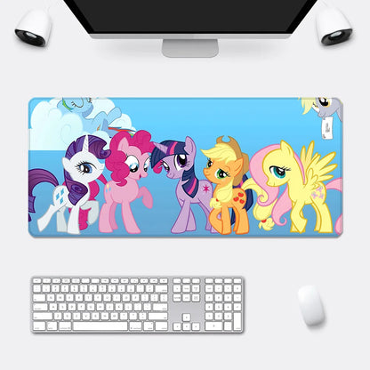 My Little Pony mousepad on a desk with keyboard and monitor, featuring colorful cartoon characters.