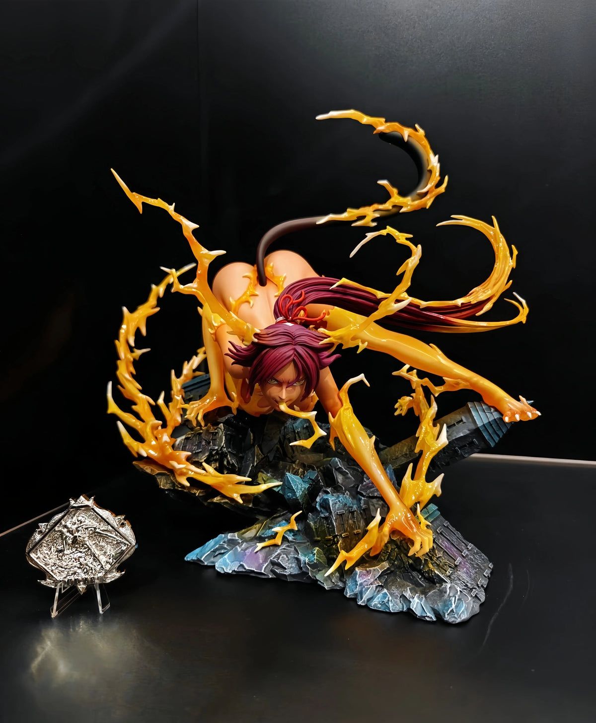 Yoruichi Shihouin anime figure with purple hair, cat tail, and orange lightning effects on a rocky base.