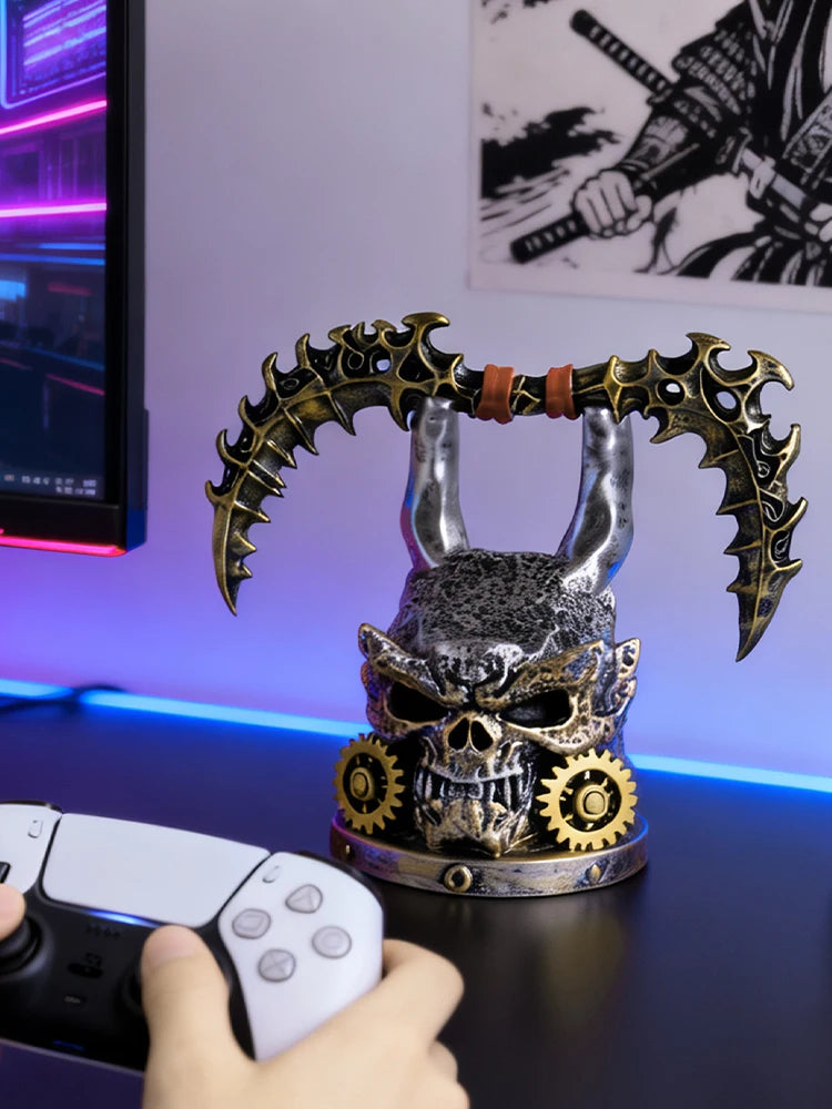 Steampunk-style skull holder in black, silver, and gold with two horns and attached gears, holding two scythe-like blades.