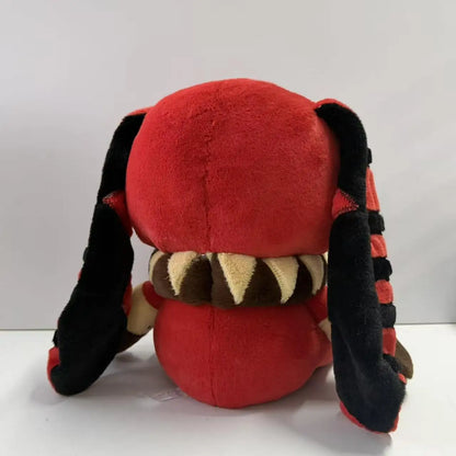 Back of a red plush toy with long black floppy ears, a ruffled collar, and striped details.