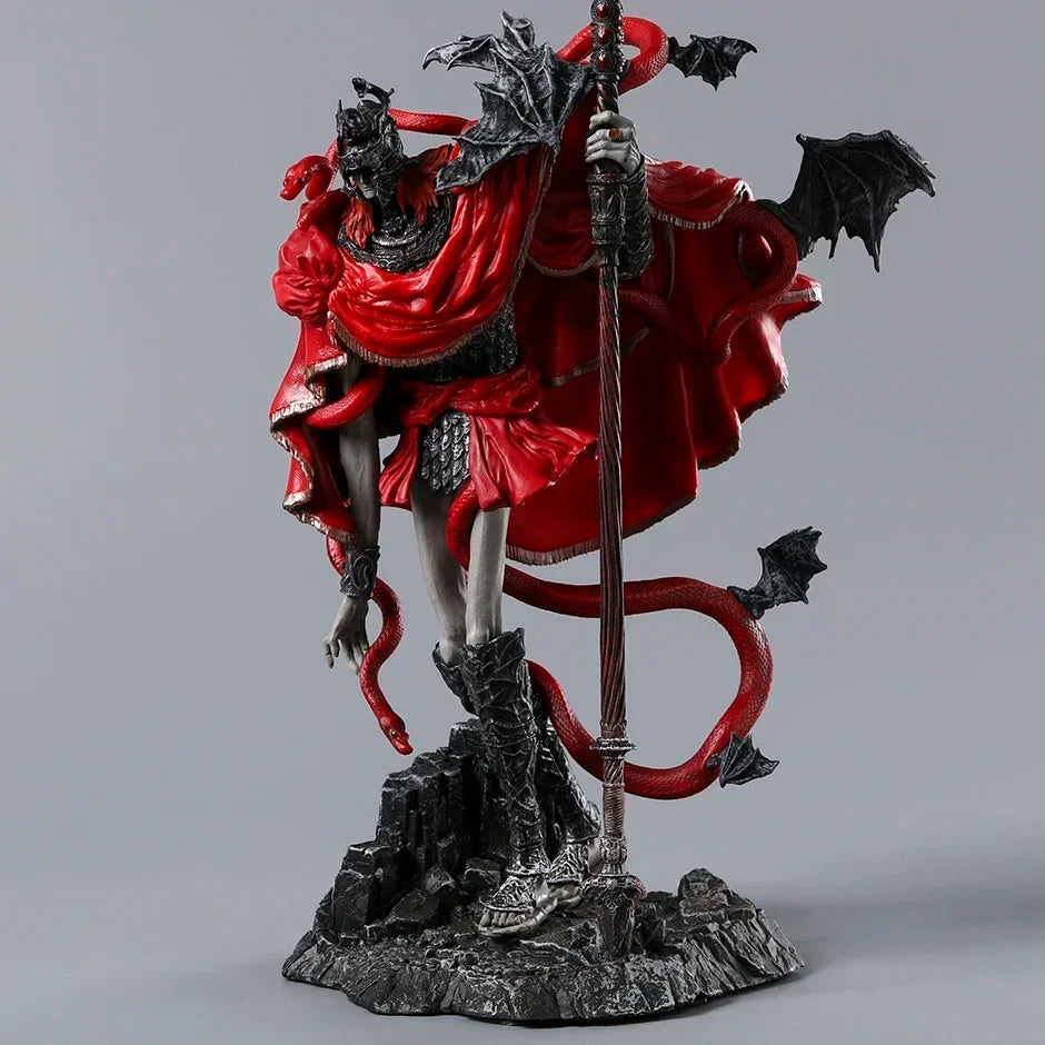 PVC figurine of an armored warrior in a red cape, holding a staff, with red snakes and black bat wings.