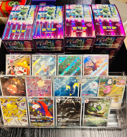 Four purple Pokémon Gem Pack 5 booster boxes sit above a display stand holding various Simplified Chinese trading cards.
