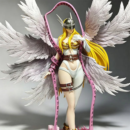 Angewomon PVC statue with large white feathered wings, a winged helmet, blonde hair, and a looping pink rune-inscribed ribbon.