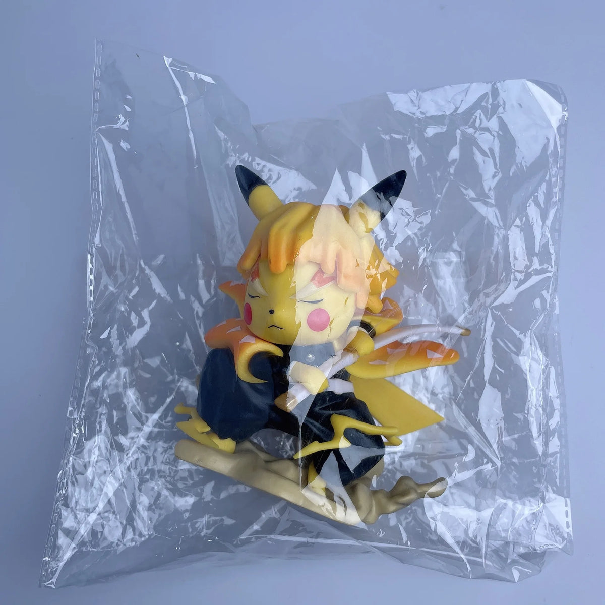 Pikachu-style Agatsuma Zenitsu figurine in a plastic bag, wearing dark pants and an orange-and-yellow patterned haori.