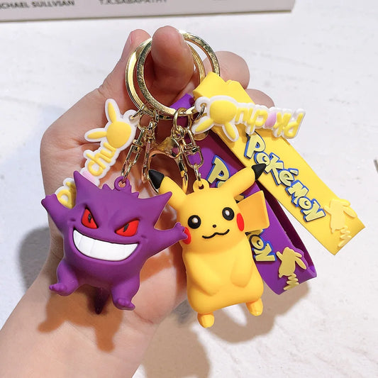 Pokemon keychain with Pikachu and Gengar silicone charms, plus yellow and purple strap accents.