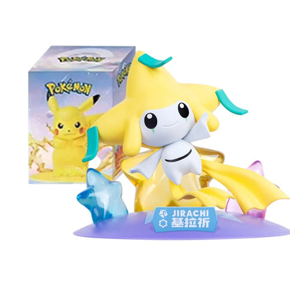Jirachi figurine in white and yellow, with a blue nameplate, on a purple base with crystal stars, beside its Pokémon box.