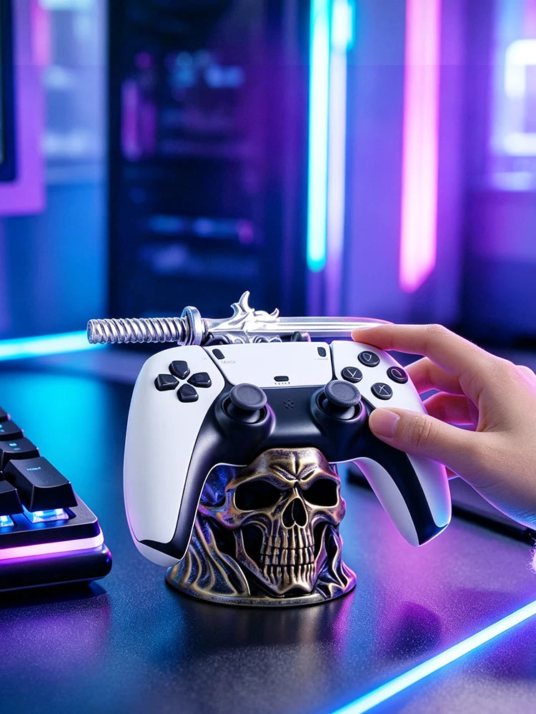 A bronze skull and sword game controller holder supports a white and black controller.
