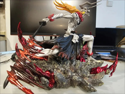 Bleach Ichigo figurine in a horned mask, pale body, dark skirt, and red energy base.