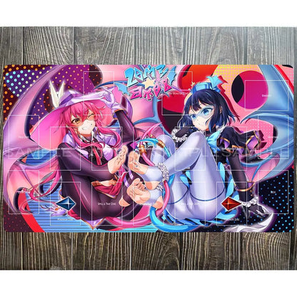 Yu-Gi-Oh playmat with two anime girls in pink and blue outfits amid game zones, colorful background, and "SAMPLE" watermark.
