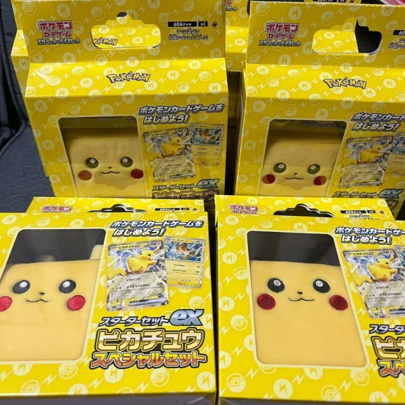 Multiple yellow Pikachu Pokémon card game starter set boxes with plush deck cases visible in windows.