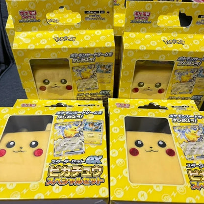 Multiple yellow Pikachu Pokémon card game starter set boxes with plush deck cases visible in windows.