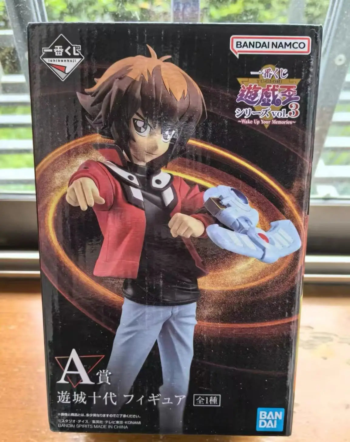 Jaden Yuki figure box in red jacket, white Duel Disk, brown hair, and blue pants.