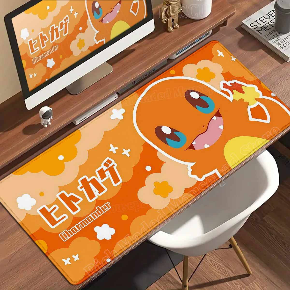 Orange Charmander desk mat with clouds, Japanese text, and white borders on a wooden desk.