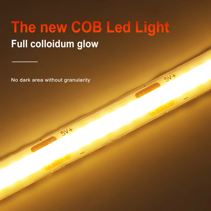 Flexible warm yellow COB LED strip light glowing brightly against a dark background.